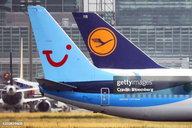 The tail fins of passenger aircraft operated by TUI AG, left, and Deutsche Lufthansa AG, at Frankfurt Airport in Frankfurt, Germany, on Tuesday, July...