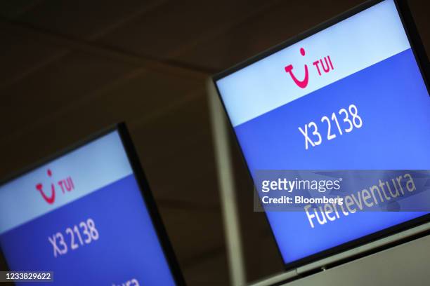 Logos on departure screens for a flight to Fuerteventura on Spain's Canary Islands, at the TUI AG passenger check-in desk at Frankfurt Airport in...