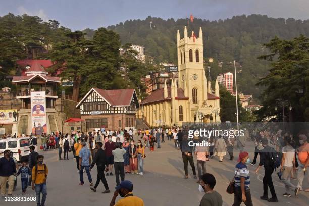 Tourists wander around the ridge area of Shimla in Himachal Pradesh state on July 6 as Indian government warned citizens against complacency as it...