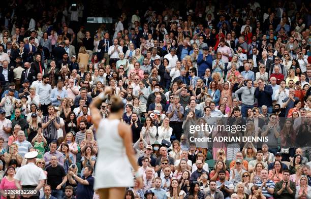 The crowd applaud as Belarus's Aryna Sabalenka celebrates winning against Tunisia's Ons Jabeur during their women's quarter-final tennis match on the...