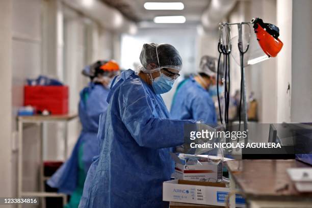 Health workers are seen at the ICU of the San Roque Hospital in Cordoba, Argentina, on July 06, 2021. - Argentina is about to reach 100,000 deaths...