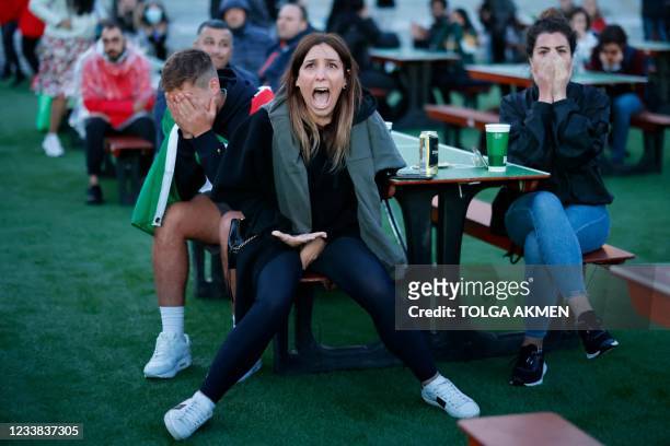 Italy's supporters react to Spain's first goal as they watch the UEFA EURO 2020 semi-final football match between Spain and Italy, at the FanZone in...
