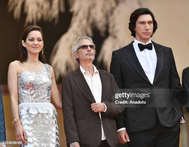 French actress Marion Cotillard , French film director Leos Carax and US actor Adam Driver arrive for the screening of the film âAnnette' in...