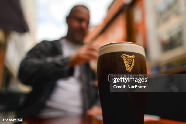 Perfect pint of Guinness on the table outside a pub in Dublin city center. On Monday, 05 July 2021, in Dublin, Ireland