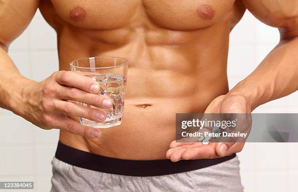 body builder taking steroids/slimming pills/drugs - steroids stock pictures, royalty-free photos & images