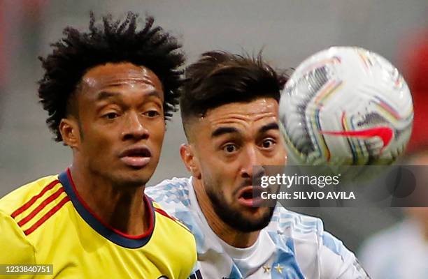 Colombia's Juan Cuadrado and Argentina's Nicolas Gonzalez vie for the ball during their Conmebol 2021 Copa America football tournament semi-final...