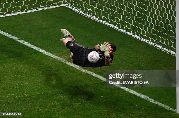 Argentina's goalkeeper Emiliano Martinez stops a ball during the penalty shootout of their Conmebol 2021 Copa America football tournament semi-final...