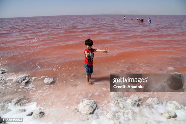 People enjoy at the Lake Urmia, one of the biggest saltwater lakes in the world located in the northwest of Iran, as it once again face a threat of...
