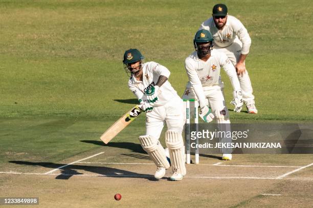 Bangladesh's Liton Das watches the ball after playing a shot as Zimbabwe's wicketkeeper Regis Chakabva and Zimbabwe's captain Brendan Taylor looks on...