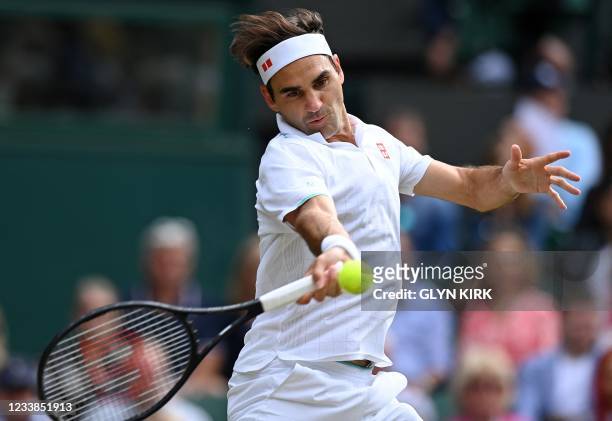 Switzerland's Roger Federer returns against Poland's Hubert Hurkacz during their men's quarter-finals match on the ninth day of the 2021 Wimbledon...