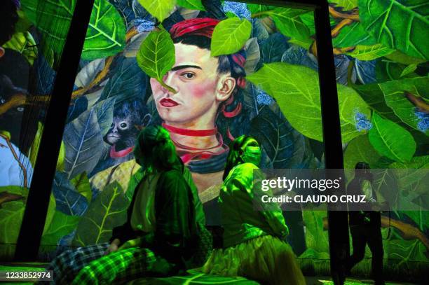 People attend the inauguration of the exhibition "Frida, the immersive experience" in Mexico City on July 6, 2021. - Images of the most famous...