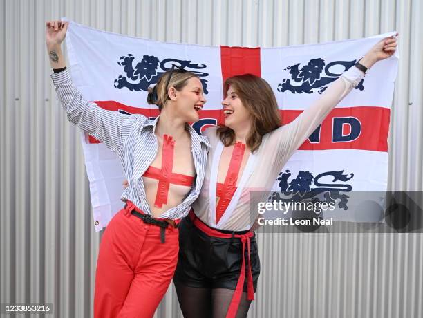 Faith Lynch and Molly Beck pose for a photo at Hackney Bridge as fans gather to watch a live broadcast of the semi-final match between England and...