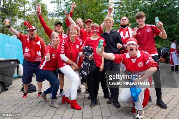 Danish supporters arrive to watch the UEFA EURO 2020 semi-final football match between England and Denmark at Wembley Stadium in London on July 7,...