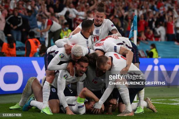 England players celebrate the goal by England's forward Harry Kane during the UEFA EURO 2020 semi-final football match between England and Denmark at...