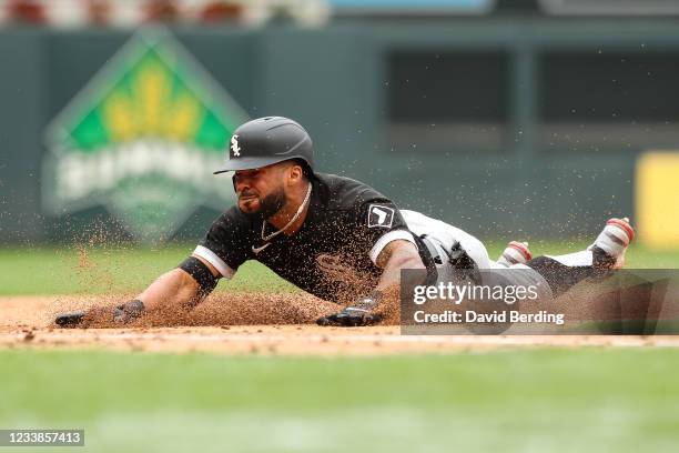 Leury Garcia of the Chicago White Sox slides into third base after hitting an RBI triple against the Minnesota Twins in the sixth inning of the game...