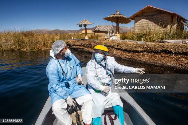 Health workers are transported to the Uros islands to inoculate citizens with a dose of the Sinopharm vaccine against COVID-19, in the Titicaca lake...