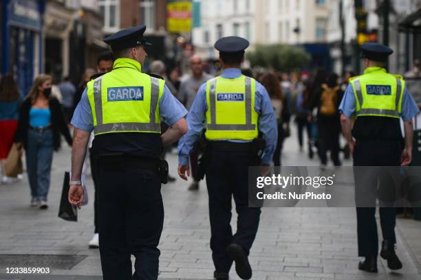 Three Garda officers seen in a busy Grafton Street in Dublin city center. On Wednesday, 07 July 2021, in Dublin, Ireland