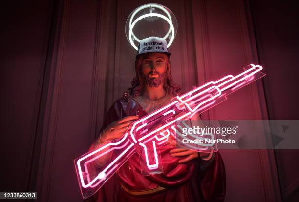 Statue of Jesus holding a neon machine gun inside the Heartbreak Social Club on Drury Street in Dublin city center. On Wednesday, 07 July 2021, in...