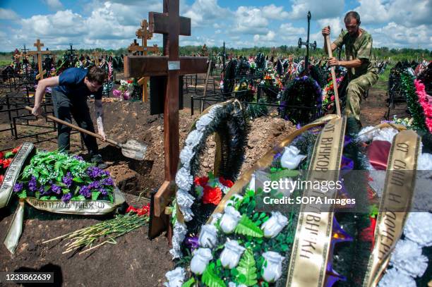 Gravediggers are seen working on a grave at the Polynkovsky cemetery. Russia has taken the second place in the world in terms of mortality from a new...