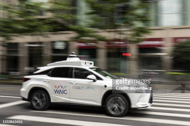 Pony.ai Inc. Autonomous vehicle with the branding of the World Artificial Intelligence Conference travels along a road in Shanghai, China, on...