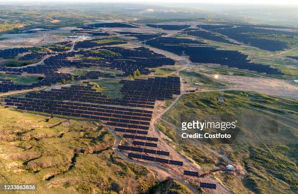 Aerial photo taken on July 8, 2021 shows a demonstration photovoltaic power generation project for ecological control of 500,000-kilowatt coal mining...