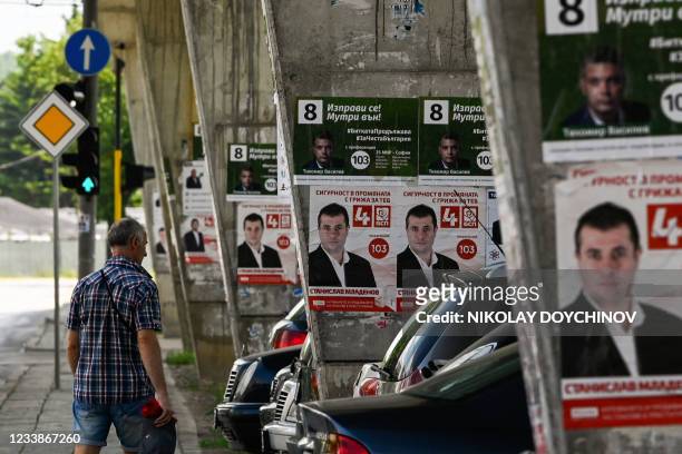 Man walks past posters of the Bulgarian Socialists party in Sofia on July 8 ahead of the parliamentary elections. - Bulgaria holds snap parliamentary...