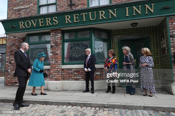 Queen Elizabeth II meets actors William Roache, fourth right, Barbara Knox, third right, Sue Nicholls and Helen Worth, right, during a visit to the...