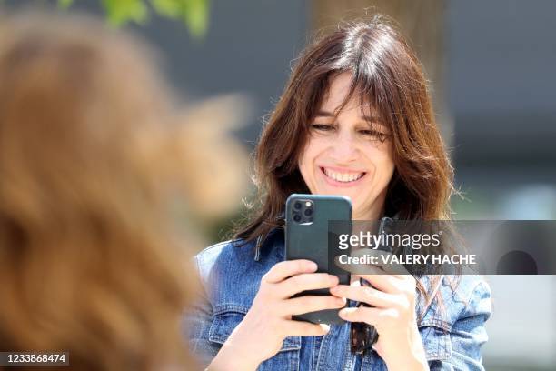 French actress, singer and director Charlotte Gainsbourg takes photos of her mother British singer and actress Jane Birkin during a photocall for the...