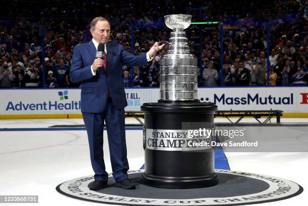 Commissioner Gary Bettman speaks alongside the Stanley Cup after the Tampa Bay Lightning 1-0 victory in Game Five of the 2021 Stanley Cup Final to...