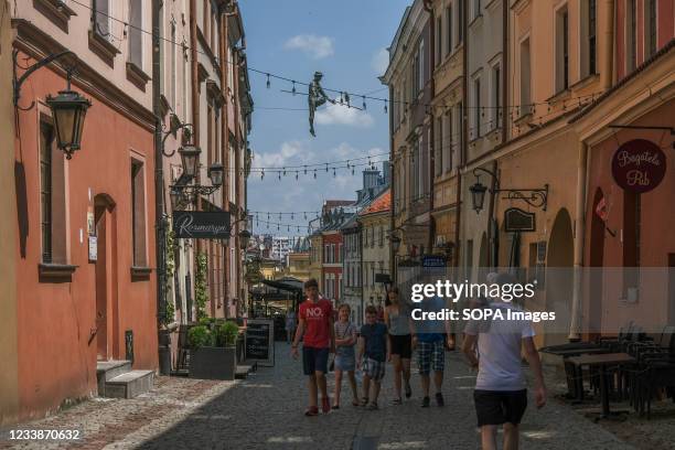 People seen walking on the old town road in summer as businesses continue to operate amid the Covid-19 pandemic.