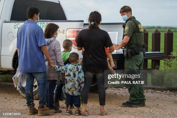 Migrants are processed by the United States Border Patrol after crossing the US-Mexico border into the United States in Penitas, Texas on July 8,...