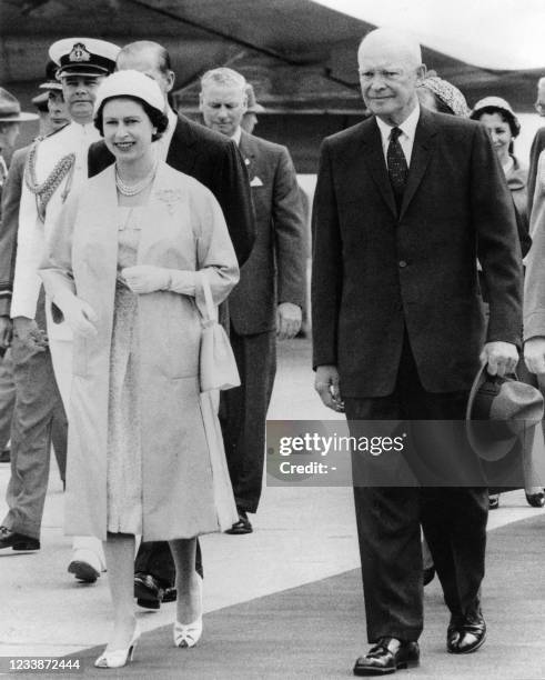 The Queen Elizabeth and President Dwight D. Eisenhower leaving the airstrip at St.Hubert, Quebec, where her Majesty greeted the President and his...