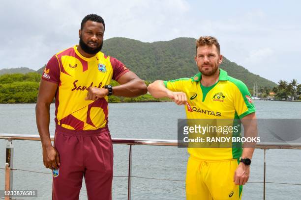Kieron Pollard of West Indies and Aaron Finch of Australia pose for a photo one day ahead of the 1st T20 between Australia and West Indies at Darren...