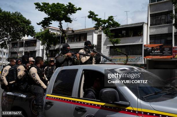Commands of the Directorate of Strategic Intelligence arrives to a main avenue of Caracas during clashes against alleged members of a criminal gang...