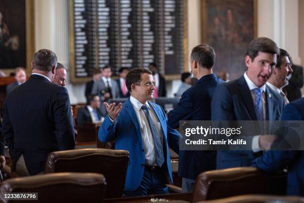 Texas state Rep. Briscoe Cain, R-Deer Park, talks with fellow state representatives in the House chamber on the first day of the 87th Legislature's...