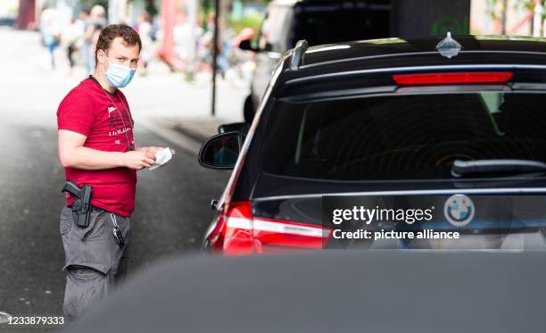 July 2021, Lower Saxony, Hanover: Hendrik Vorreiter of the Hanover police carries out a vehicle check in the city centre. Police officers in Hanover...