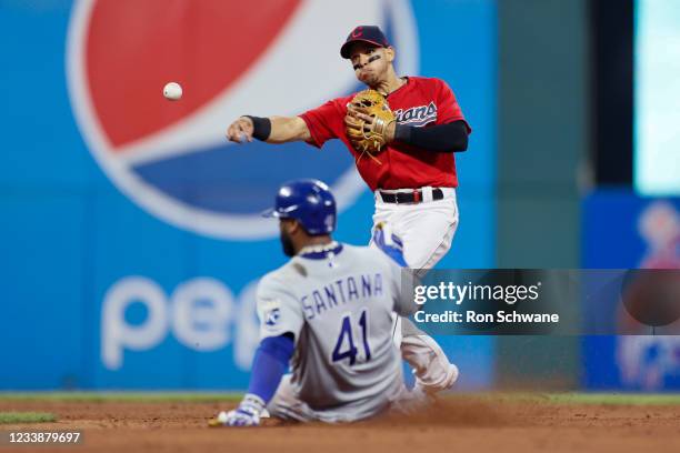 Cesar Hernandez of the Cleveland Indians throws to first base after forcing out Carlos Santana of the Kansas City Royals at second base to complete...