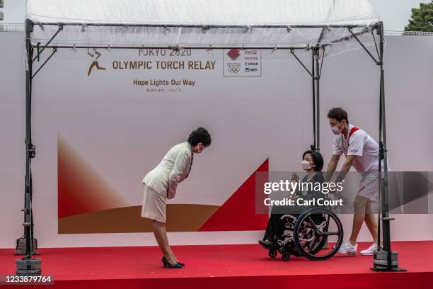 Tokyo Governor Yuriko Koike greets Aki Taguchi, official ambassador of the Tokyo 2020 torch relay , and Shuzo Matsuoka, the first torch bearer for...