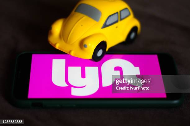 Lyft logo displayed on a phone screen is seen in this illustration photo taken in Krakow, Poland on July 8, 2021.