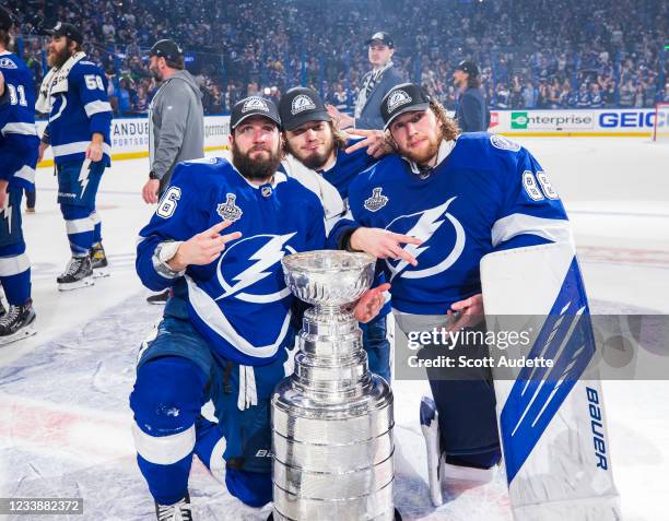 Nikita Kucherov, Mikhail Sergachev, and goalie Andrei Vasilevskiy of the Tampa Bay Lightning celebrates with the Stanley Cup after defeating the...