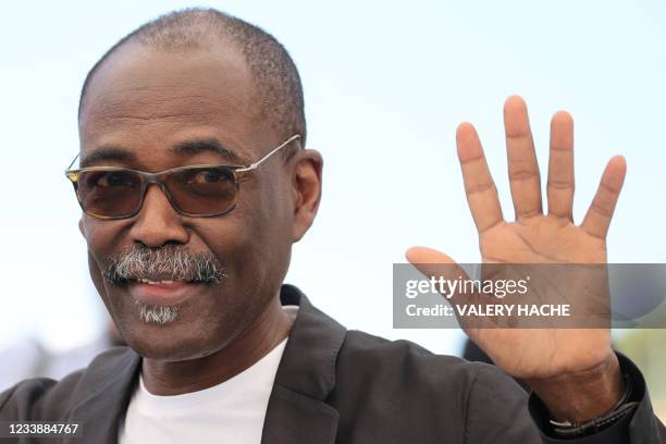 Chadian director Mahamat-Saleh Haroun waves during a photocall for the film "Lingui" at the 74th edition of the Cannes Film Festival in Cannes,...