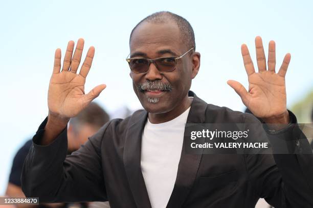 Chadian director Mahamat-Saleh Haroun waves during a photocall for the film "Lingui" at the 74th edition of the Cannes Film Festival in Cannes,...