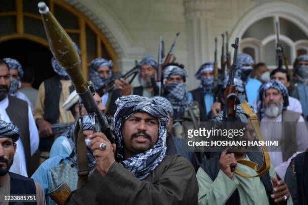 Afghan militia gather with their weapons to support Afghanistan security forces against the Taliban, in Afghan warlord and former Mujahideen leader...