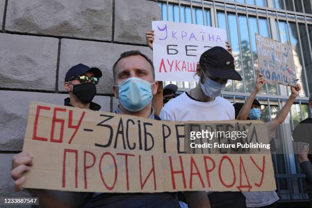 Demonstrator holds a placard during the No to Political Deportations! rally outside the Ukrainian Security Service building held to urge the security...