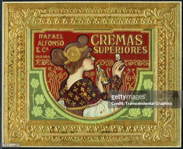Cremas liquor company employs a gold bordered label to promote the business late 1800s or early 1900s in Havana, Cuba.