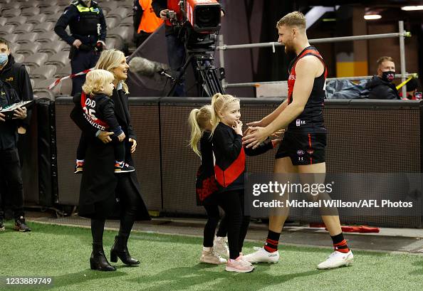 Jake Stringer of the Bombers greets partner Taylor McVeigh and... News ...