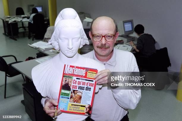 French journalist Jean-François Kahn poses on April 22, 1997 in Paris next to a Marianne bust, a national symbol of the French republic, with the...