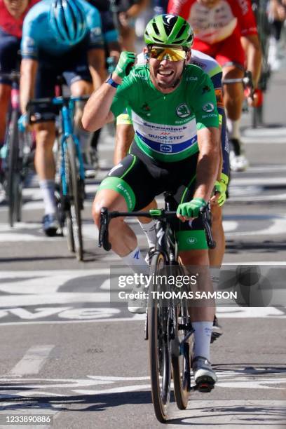 Stage winner Team Deceuninck Quickstep's Mark Cavendish of Great Britain wearing the best sprinter's green jersey crosses the finish line at the end...