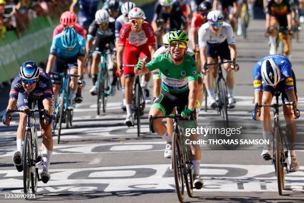 Stage winner Team Deceuninck Quickstep's Mark Cavendish of Great Britain wearing the best sprinter's green jersey crosses the finish line at the end...
