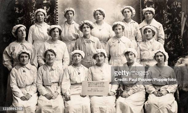 Vintage postcard featuring a group of women workers in the Shell Shop or munitions factory at the Woolwich Arsenal during World War One, circa 1916.